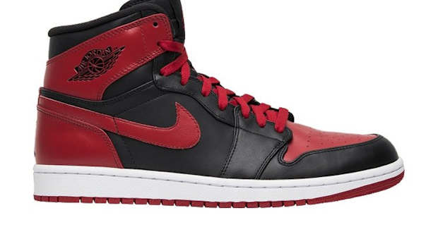 Side view of red and black Air Jordan sneakers.